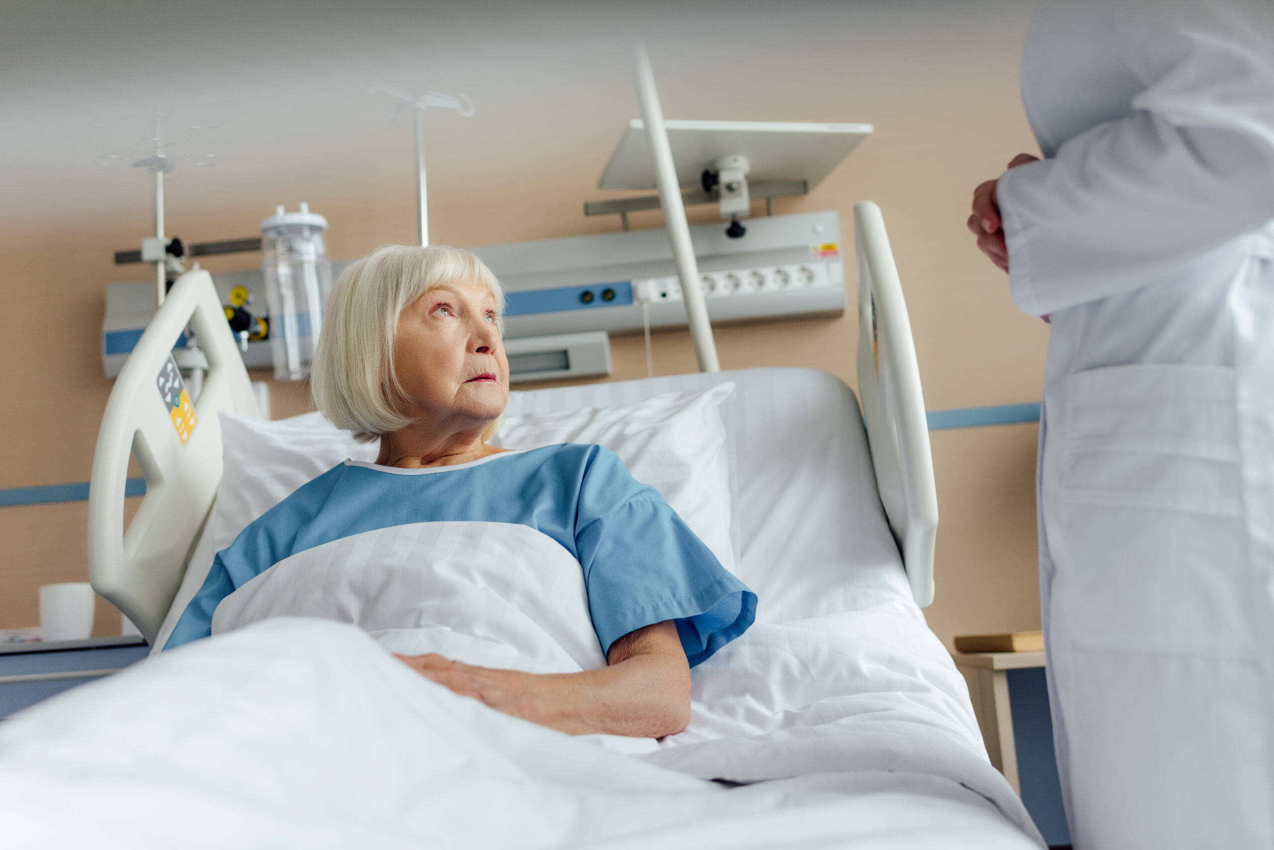 senior hospital patient in bed